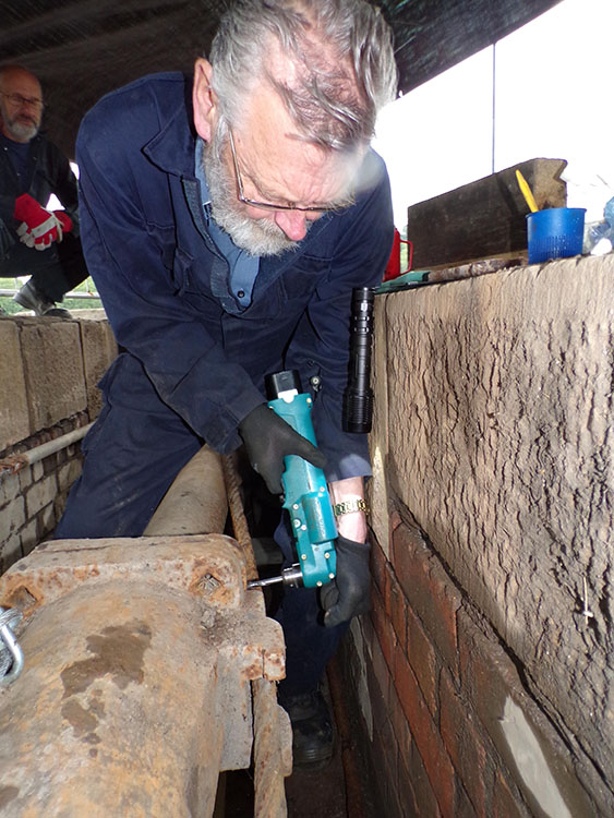 David drilling a hole to repair a cracked flange in the ram-pit